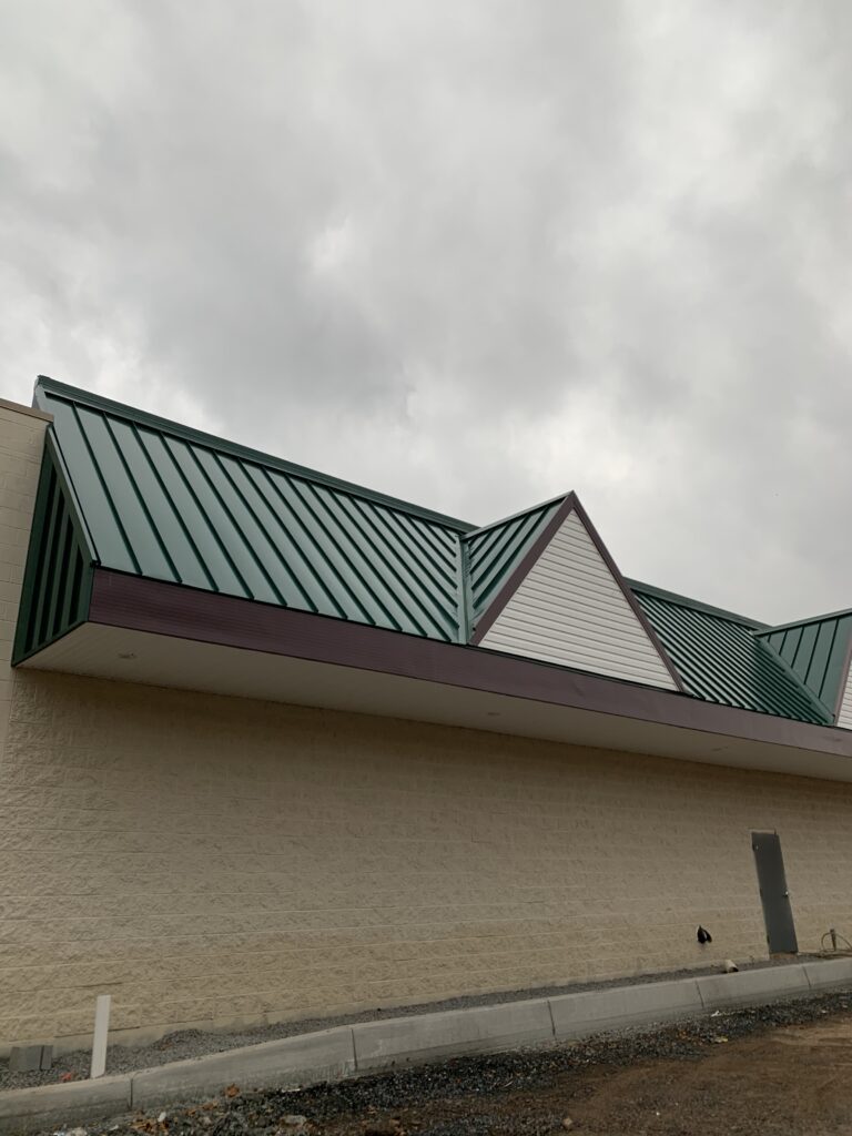 Standing seam metal roof. Green metal roof with burgundy trim.